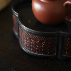 The Takumei Woven Tin Tray by Piexlculpt blends woven rattan warmth with tin craftsmanship. Its handcrafted dual-use design functions as both a tea holder and water tray, offering a refined harmony of practicality