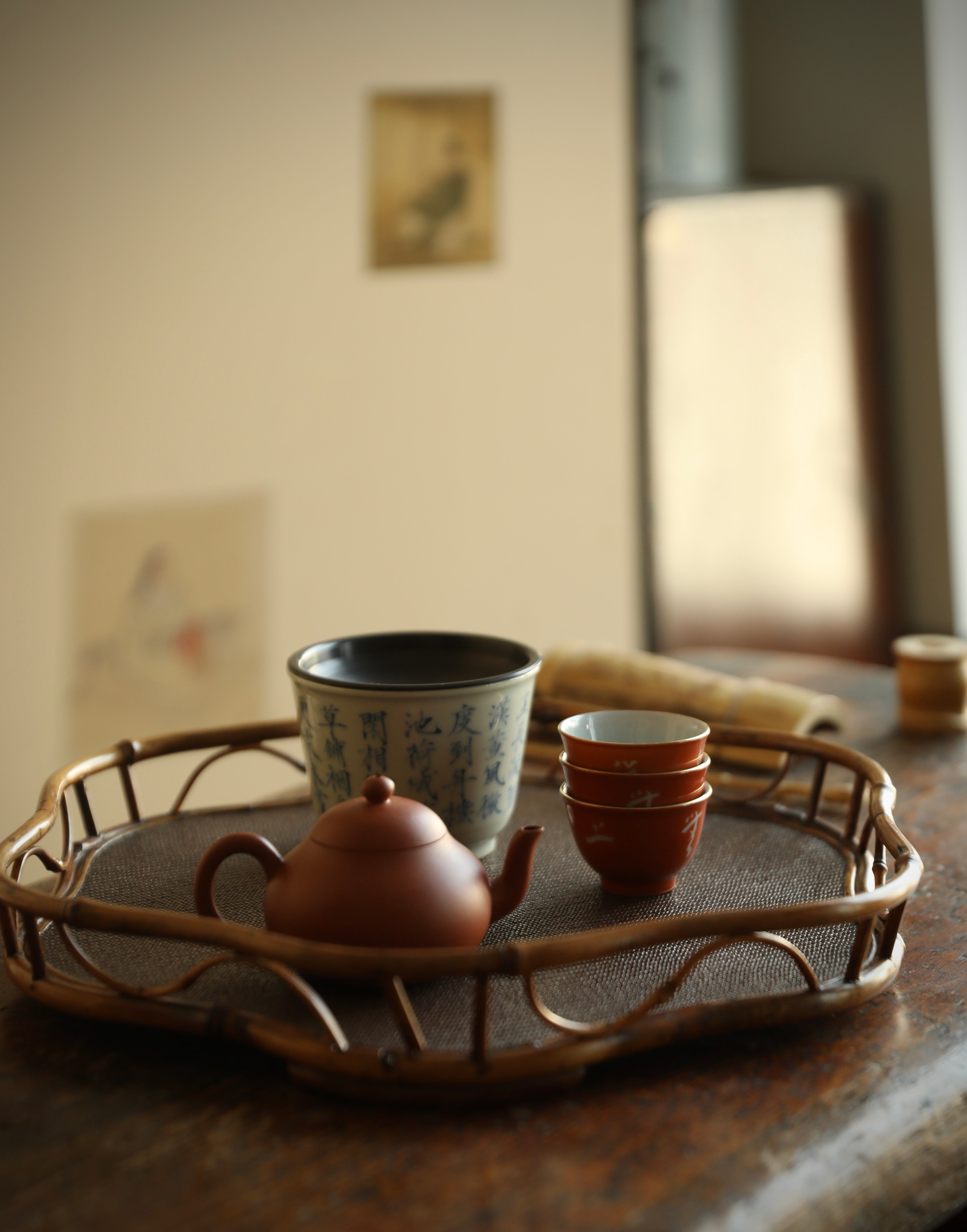 The Shirabe Bamboo Tray by Piexlculpt is a handcrafted tea tray combining purple bamboo and rattan weaving in a plum blossom frame design. Its light yet sturdy form embodies balance and grace