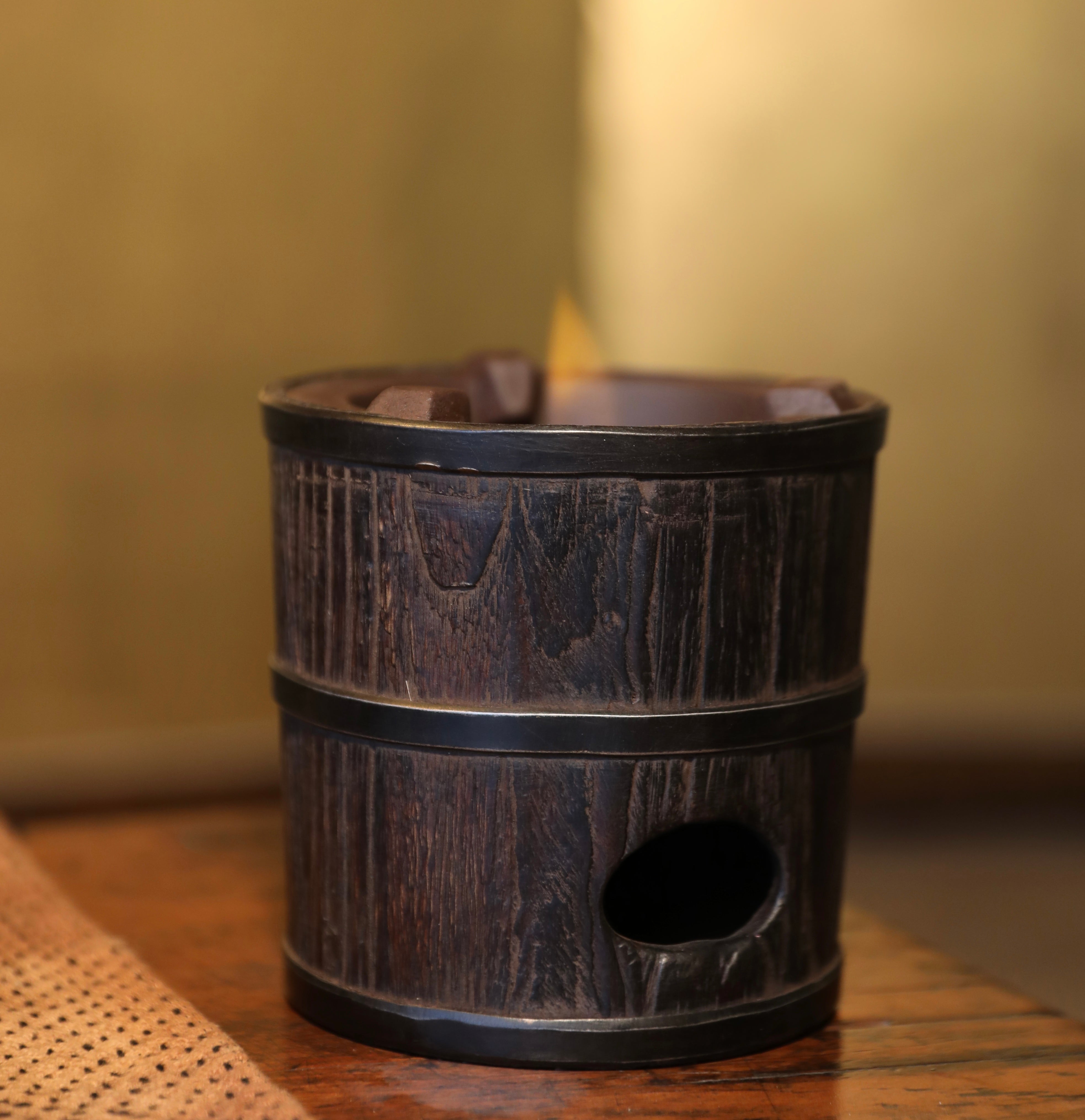 elmwood tea stove, wood fired tea heater, charcoal brazier, traditional tea stove, handcrafted tea accessories, artisan tea tools, vintage tea set, wood engraving art, Piexlculpt Studio, wooden tea warmer