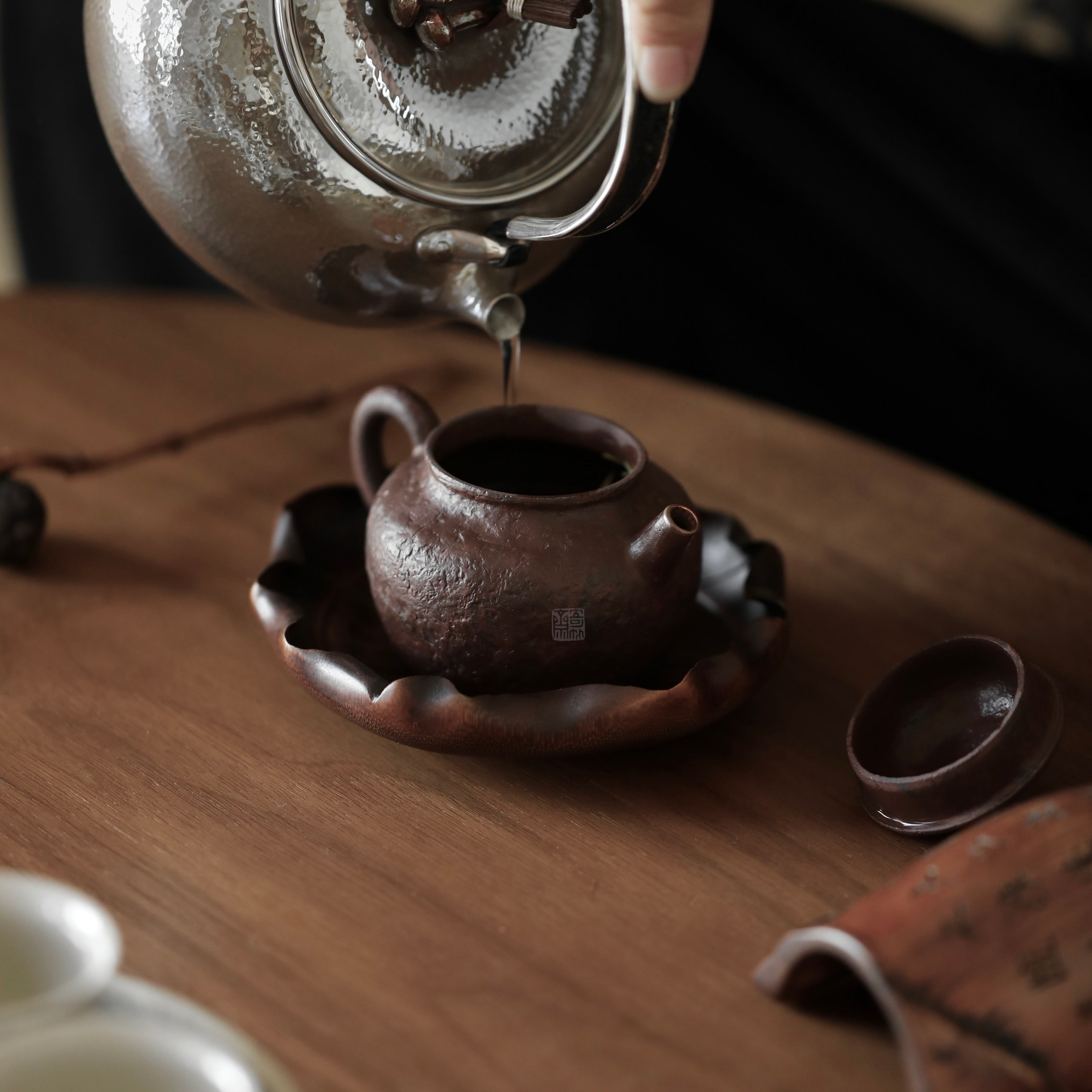 The Hasu Bamboo Tea Holder by Piexlculpt features a handcrafted lotus-leaf design made from aged bamboo and natural lacquer. Its hand-shaped curves and organic texture celebrate the beauty of imperfection