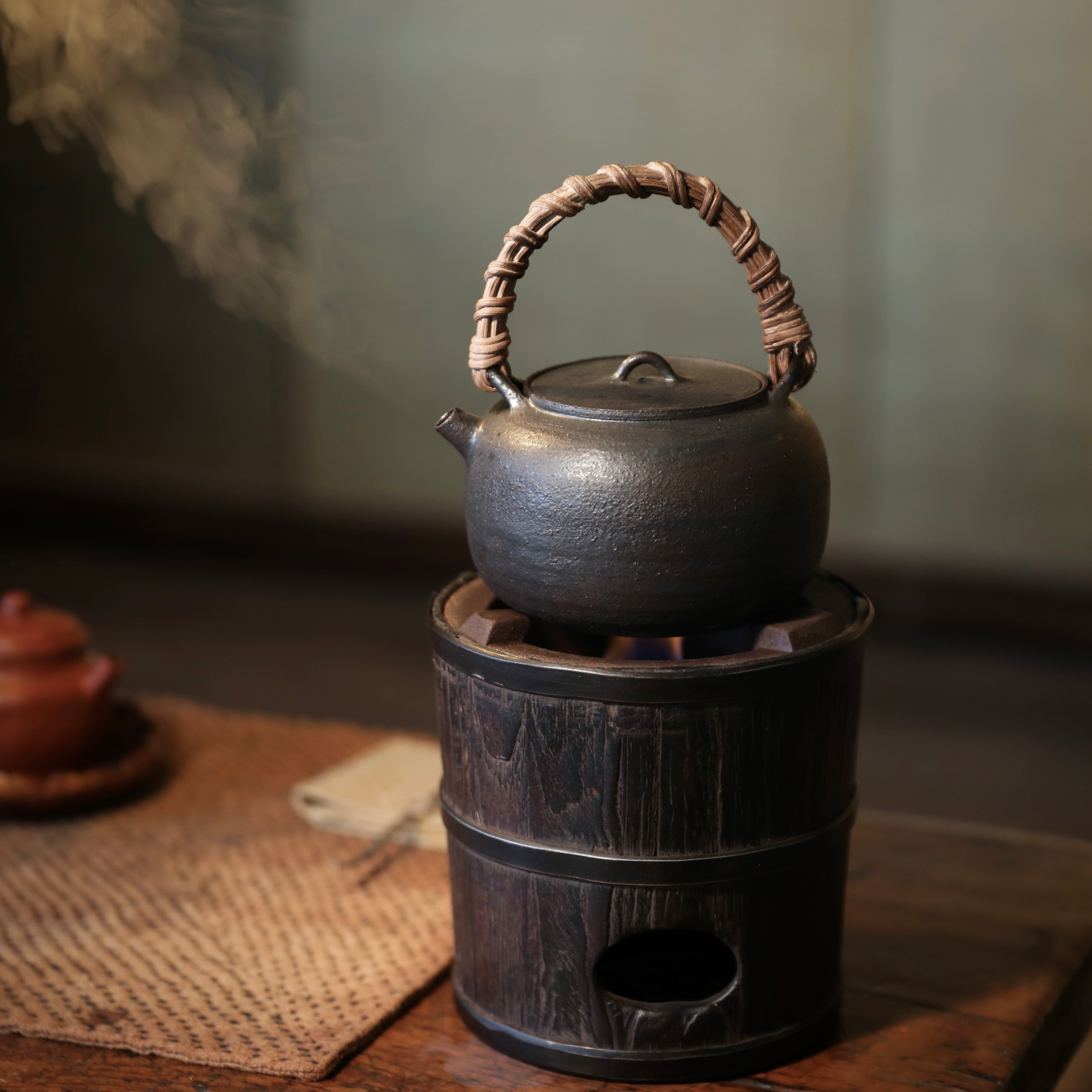 elmwood tea stove, wood fired tea heater, charcoal brazier, traditional tea stove, handcrafted tea accessories, artisan tea tools, vintage tea set, wood engraving art, Piexlculpt Studio, wooden tea warmer