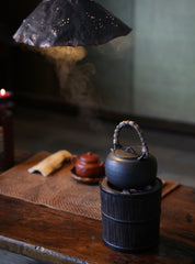 elmwood tea stove, wood fired tea heater, charcoal brazier, traditional tea stove, handcrafted tea accessories, artisan tea tools, vintage tea set, wood engraving art, Piexlculpt Studio, wooden tea warmer