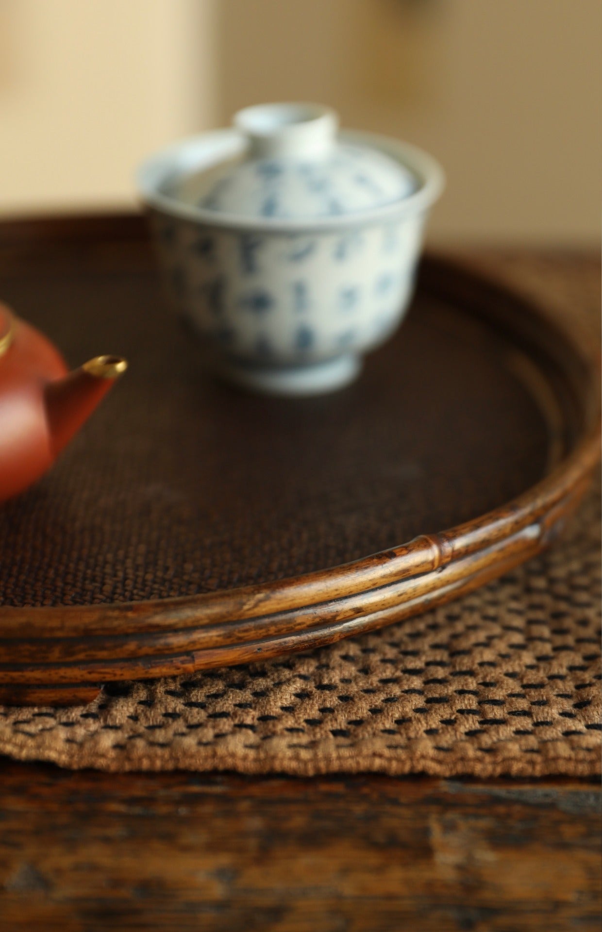The Kosei Woven Bamboo Tray by Piexlculpt is crafted by hand from natural bamboo, offering two unique finishes: deep purple bamboo and warm brown bamboo. Its circular woven design reflects the calm
