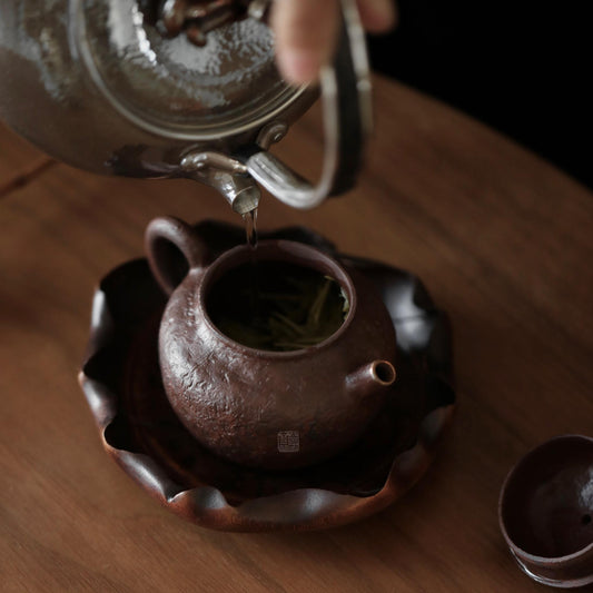 The Hasu Bamboo Tea Holder by Piexlculpt features a handcrafted lotus-leaf design made from aged bamboo and natural lacquer. Its hand-shaped curves and organic texture celebrate the beauty of imperfection