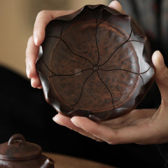 The Hasu Bamboo Tea Holder by Piexlculpt features a handcrafted lotus-leaf design made from aged bamboo and natural lacquer. Its hand-shaped curves and organic texture celebrate the beauty of imperfection