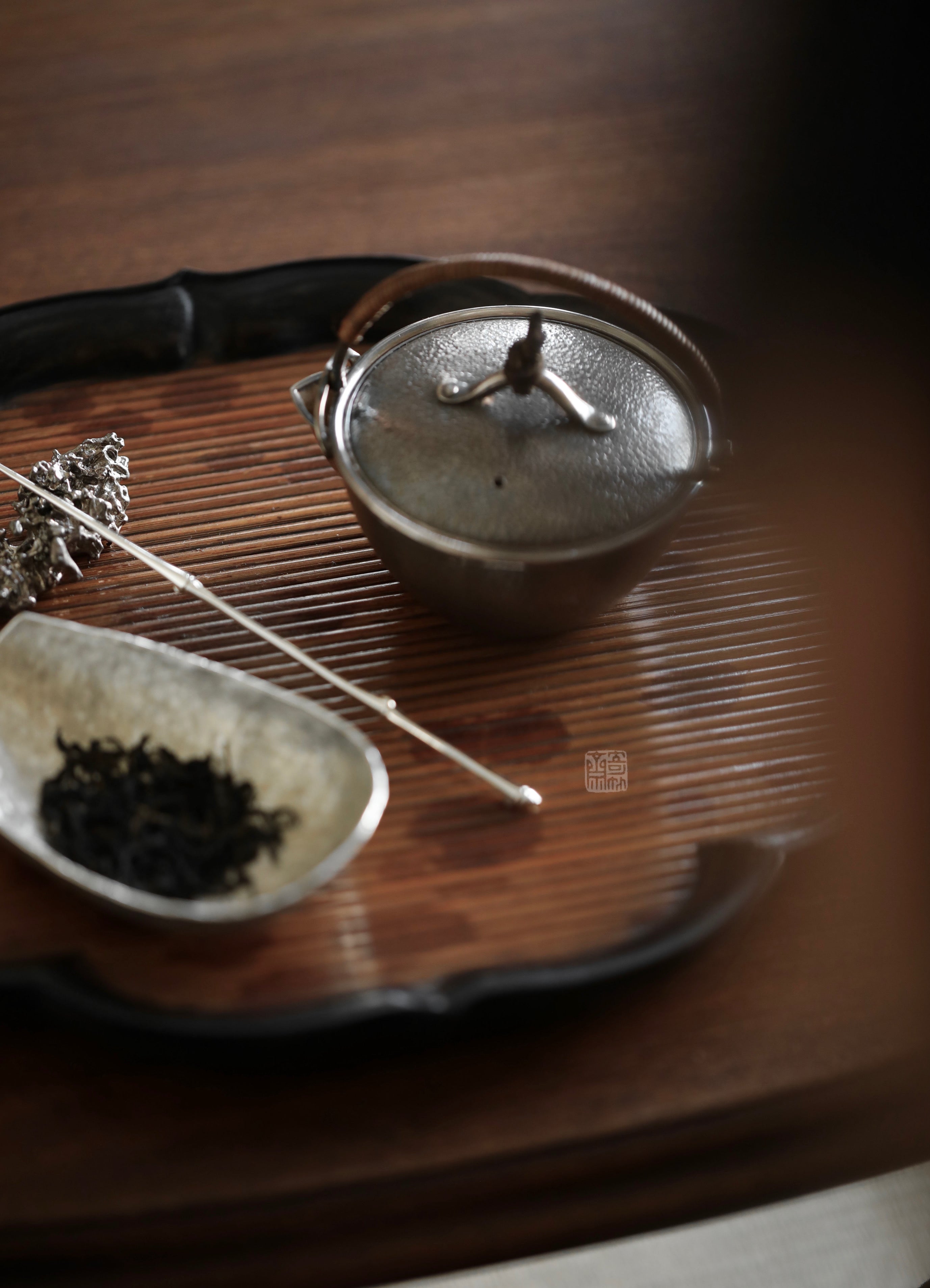 he Hibara Bamboo Tray by Piexlculpt is a handcrafted tea tray made from red Xiangfei bamboo, featuring both square and lotus-petal designs. With its elegant vintage tone and refined edges, it embodies
