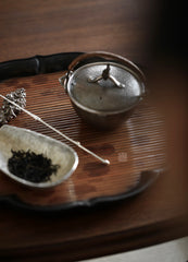he Hibara Bamboo Tray by Piexlculpt is a handcrafted tea tray made from red Xiangfei bamboo, featuring both square and lotus-petal designs. With its elegant vintage tone and refined edges, it embodies